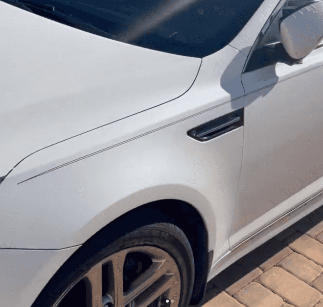 White Kia front fender and wheel before exterior detailing